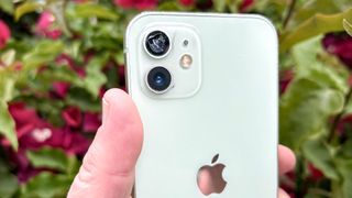 An iPhone 12 with a shattered camera lens