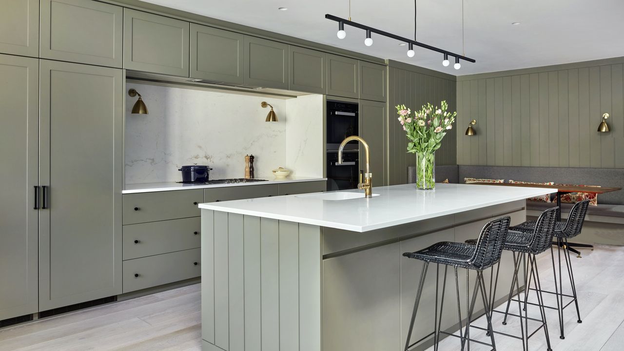 green-grey shaker kitchen with island and beadboard paneling 