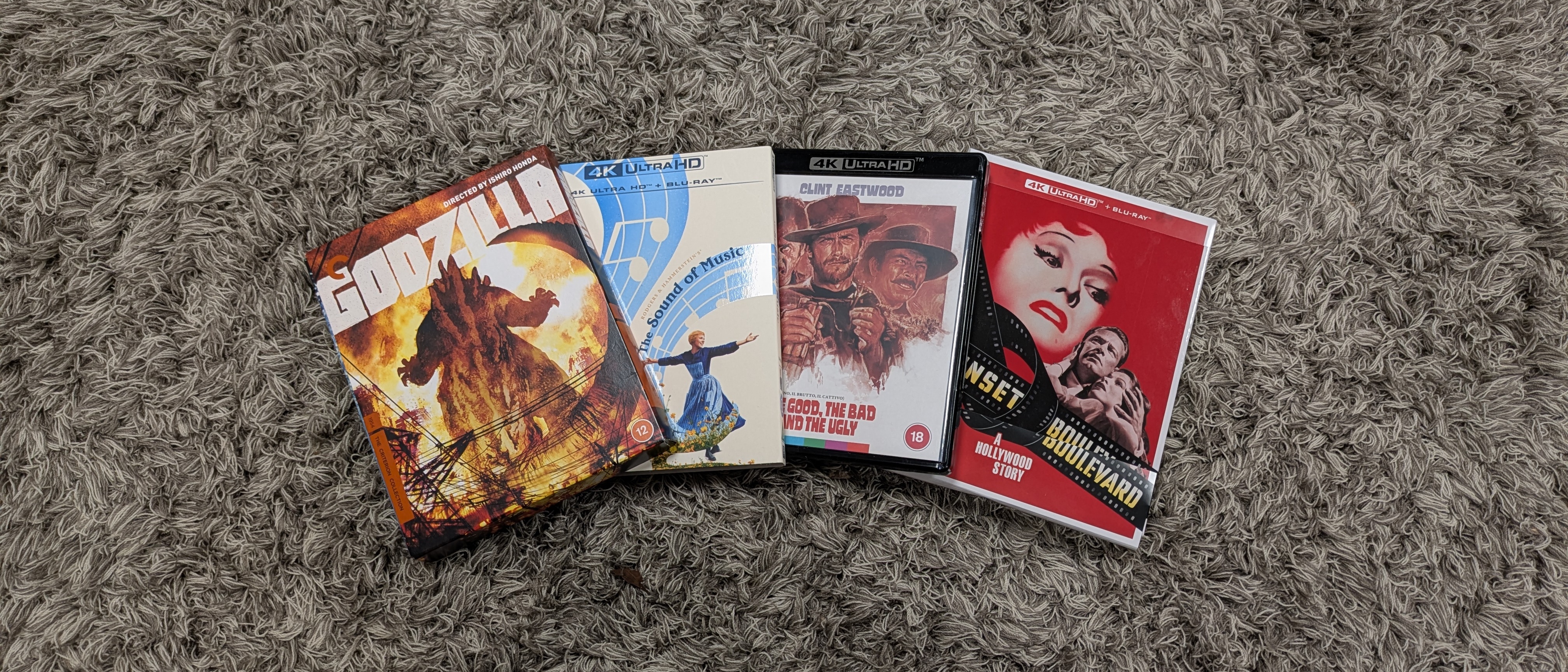 4K Blu-ray collections image showing Godzilla, Sunset Boulevard, The Sound of Music and The Good the Bad and the Ugly on a carpet 