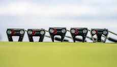 Five Scotty Cameron models lying on the ground