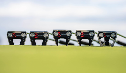 Five Scotty Cameron models lying on the ground