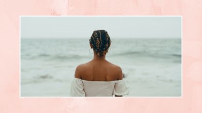 Cropped shot of an unrecognizable woman standing alone on the beach and looking out at the sea in contemplation