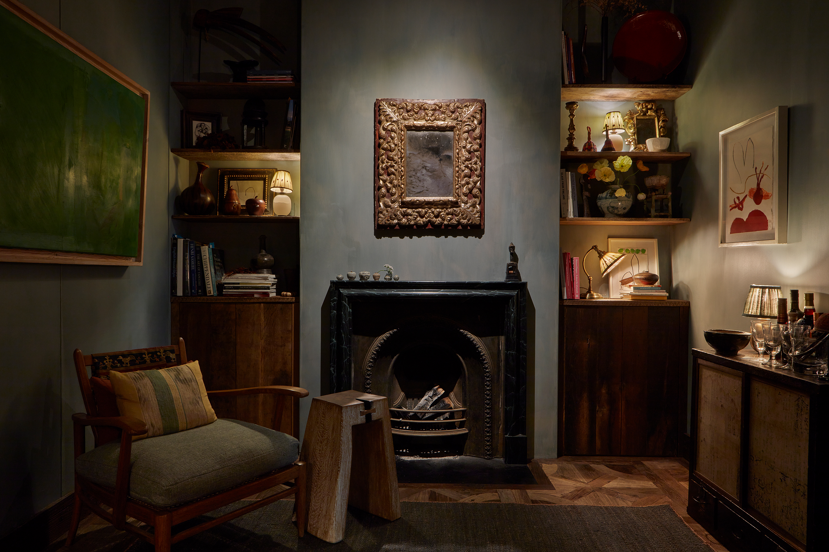 Dark toned room with blue walls and brown furniture 