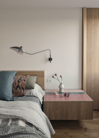 A bedroom with decorated bedside table