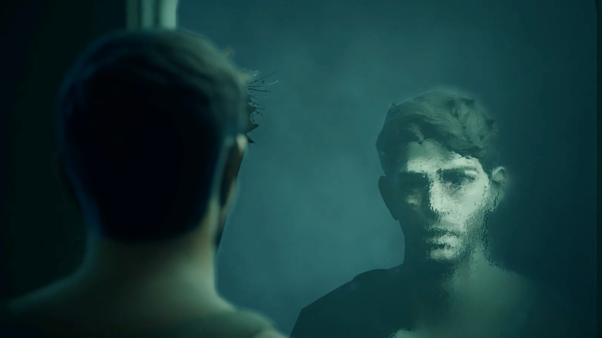 A man stares at himself in the mirror