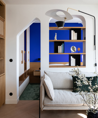 Yves Klein® Shade of blue on bedroom wall in the background of white dividing wall with couch in front