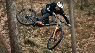 Atherton Bike's new AM170 being jumped in the woods
