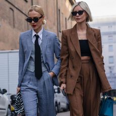 Milan, Italy - 20 February 2020: Stylish persons are posing for photographers before Max Mara fashion show on Milan Woman's Fashion Week F/W2020-2021, street style - stock photo