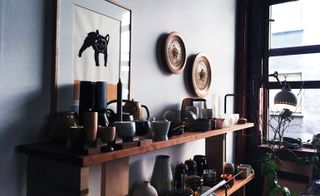 Wooden shelves with assorted ceramic pots