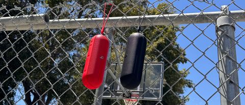 Beats Pill hangin from fence at basketball court