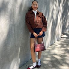 anneliese henderson wearing a mini skirt flats and brown jacket for fall