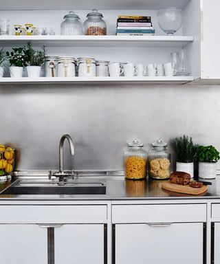 A kitchen with stainless steel splashback