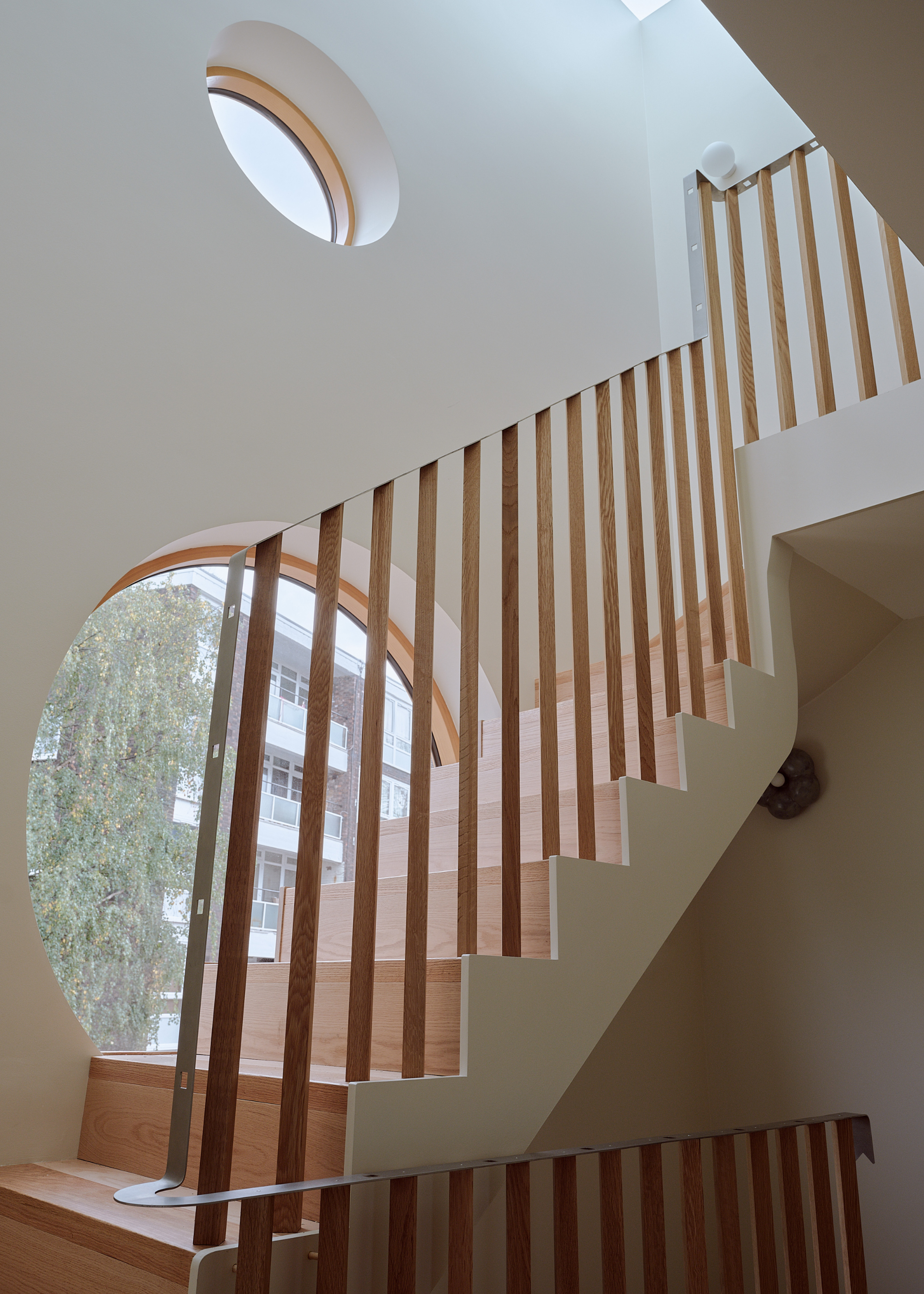 wooden staircase with round windows on the wall