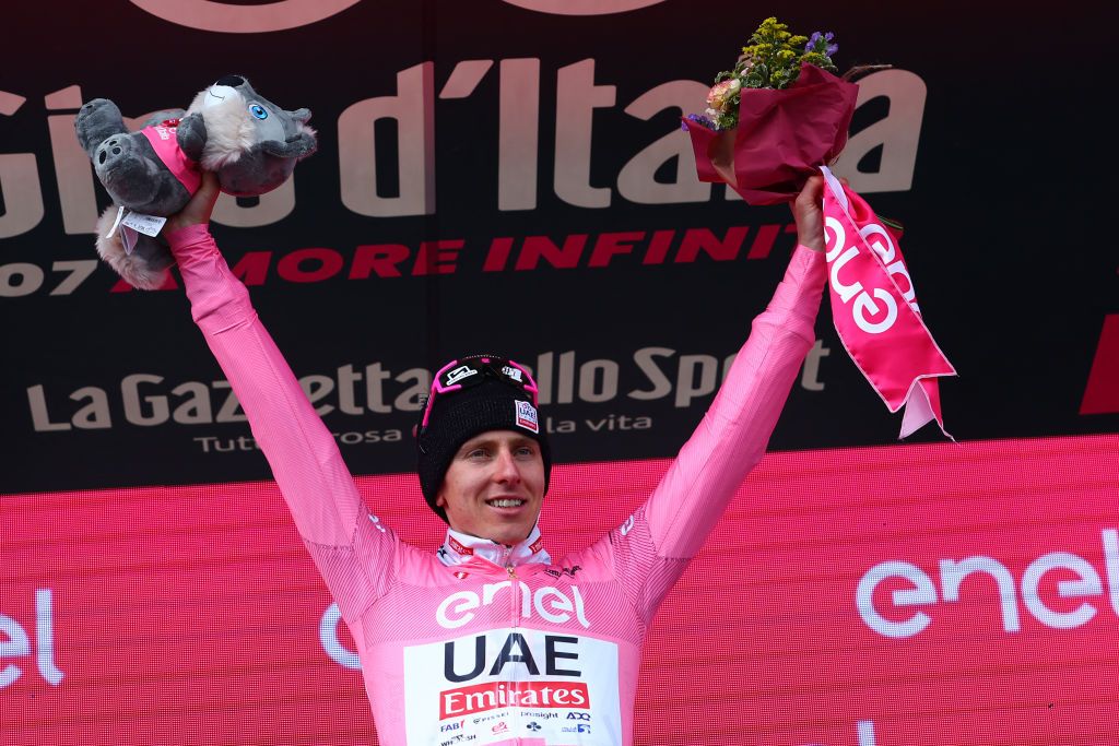 Pink jersey Team UAE's Slovenian rider Tadej Pogacar celebrates on the podium after winning the 15th stage of the 107th Giro d'Italia cycling race, 222km between Manerba del Garda and Mottolino on May 19, 2024. (Photo by Luca Bettini / POOL / AFP)