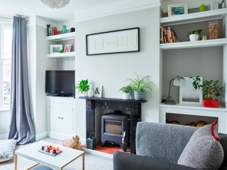 a living room with a tv in an alcove