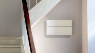 Lifestyle image of a closed British General consumer unit in hallway next to stairs