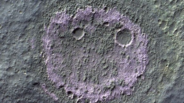 A pink smiley face with meteor craters for eyes on the surface of mars