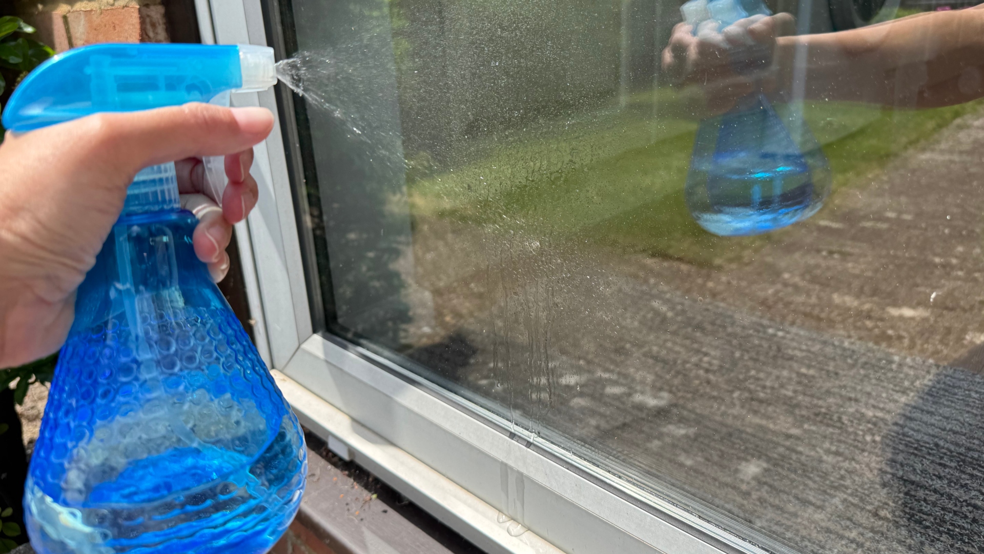 Using newspaper and vinegar to clean a window