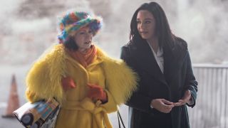 From left to right: Elsbeth and Kaya walking outside together and talking.