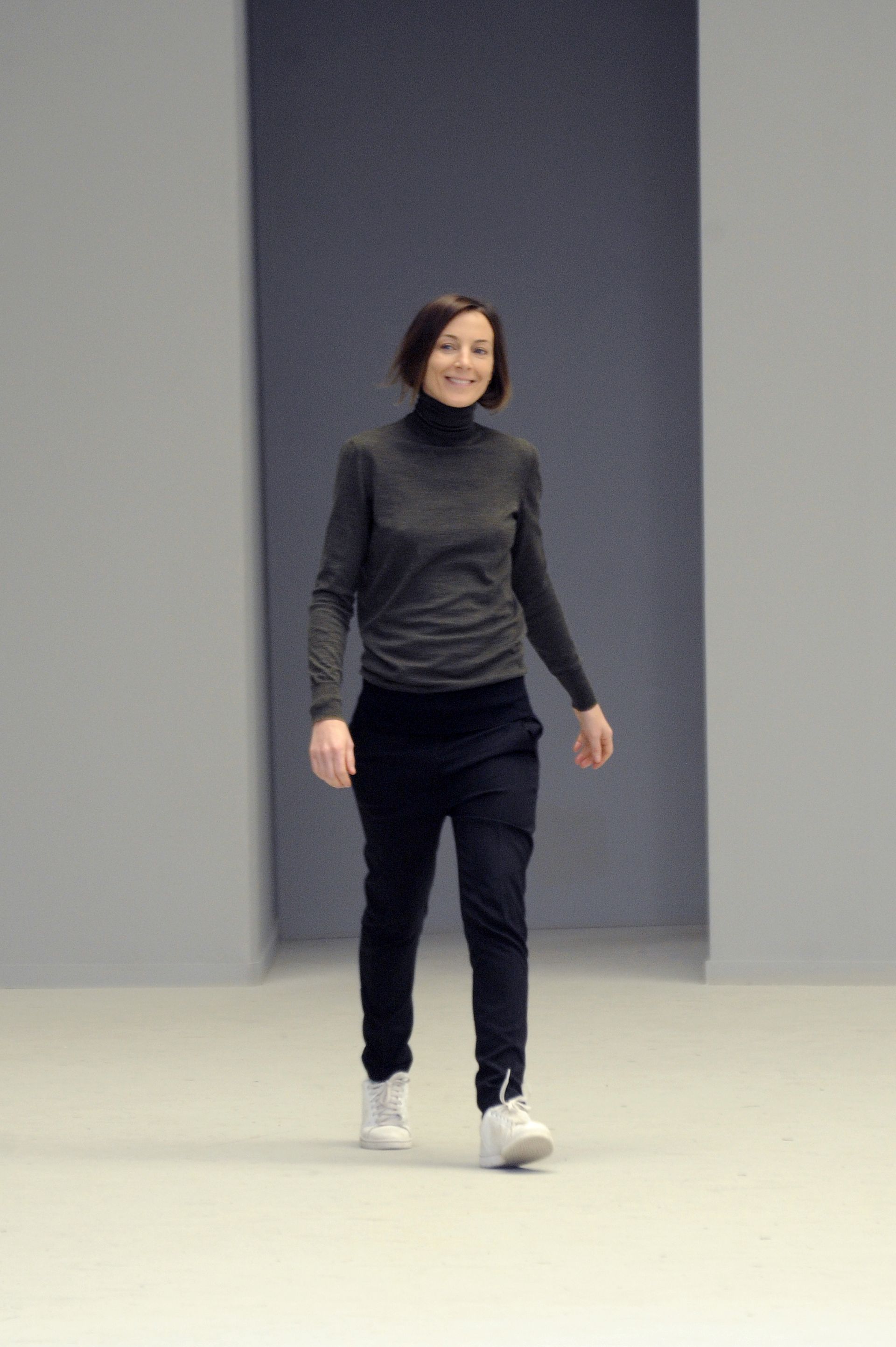 An image of Phoebe Philo wearing a grey turtleneck at Celine's autumn/winter 2021 show.