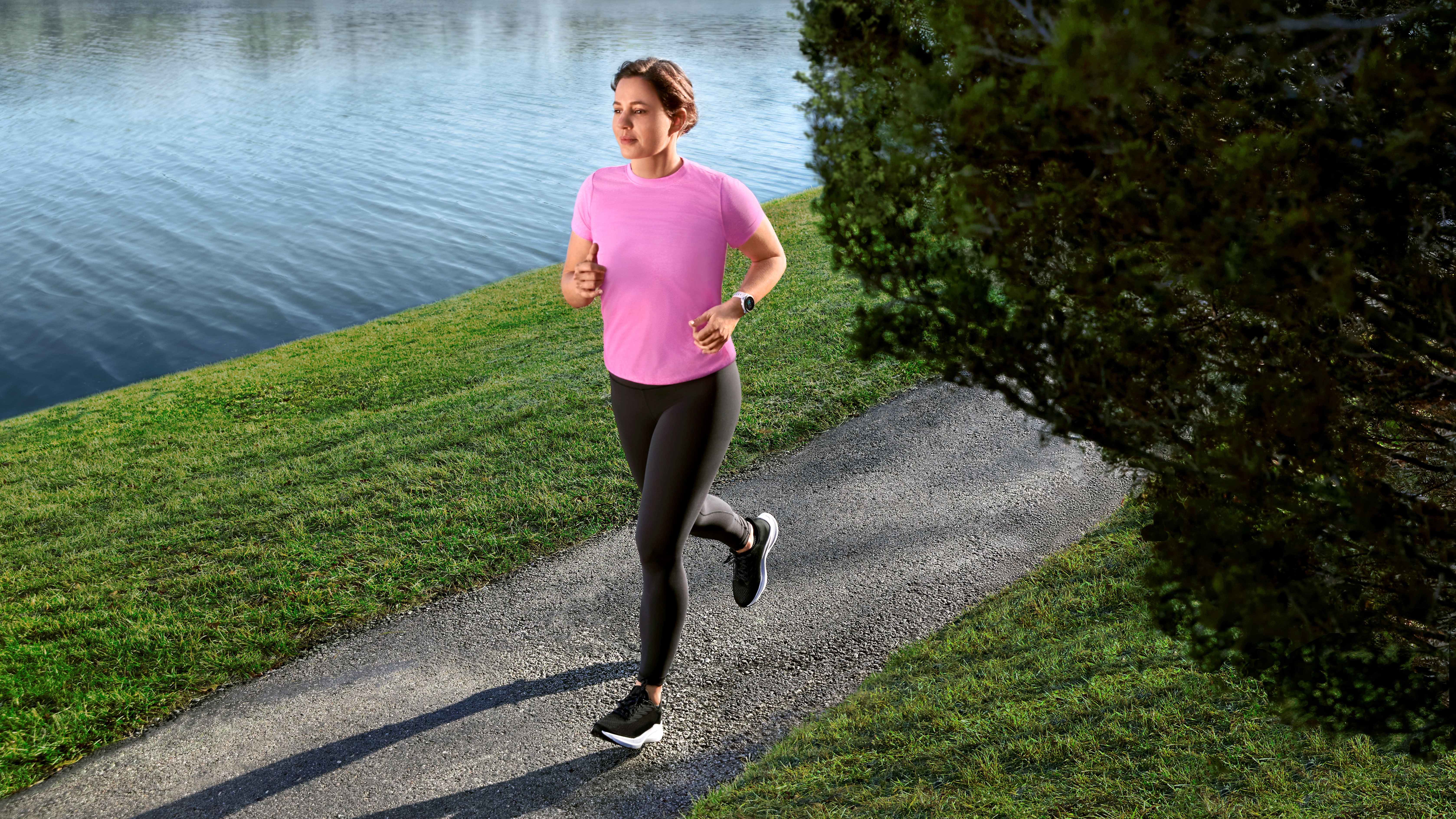 Woman running while wearing a Garmin Forerunner 55