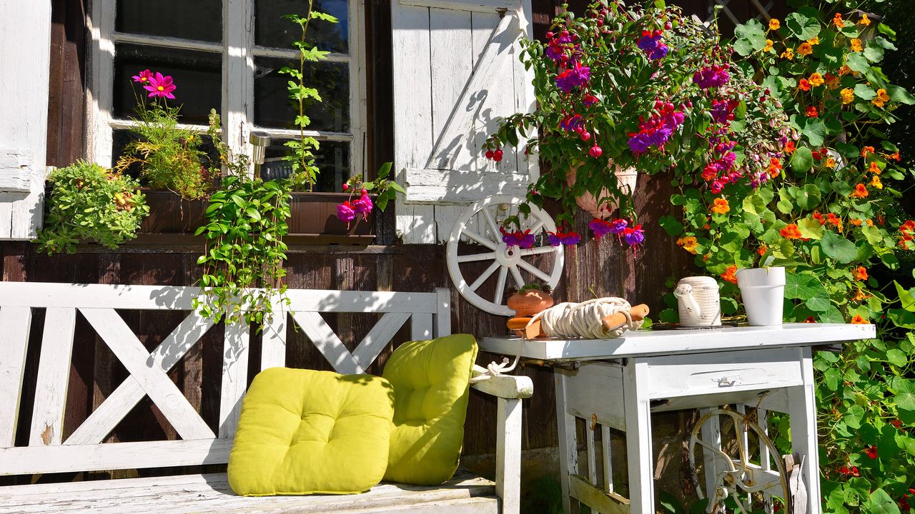 rustic garden ideas: old wooden bench and table in front of a cottage