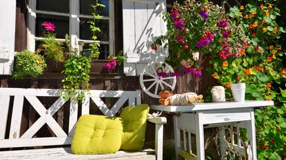 rustic garden ideas: old wooden bench and table in front of a cottage