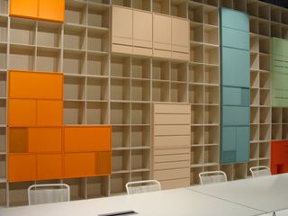 Shelving in shades of pastel and strong orange