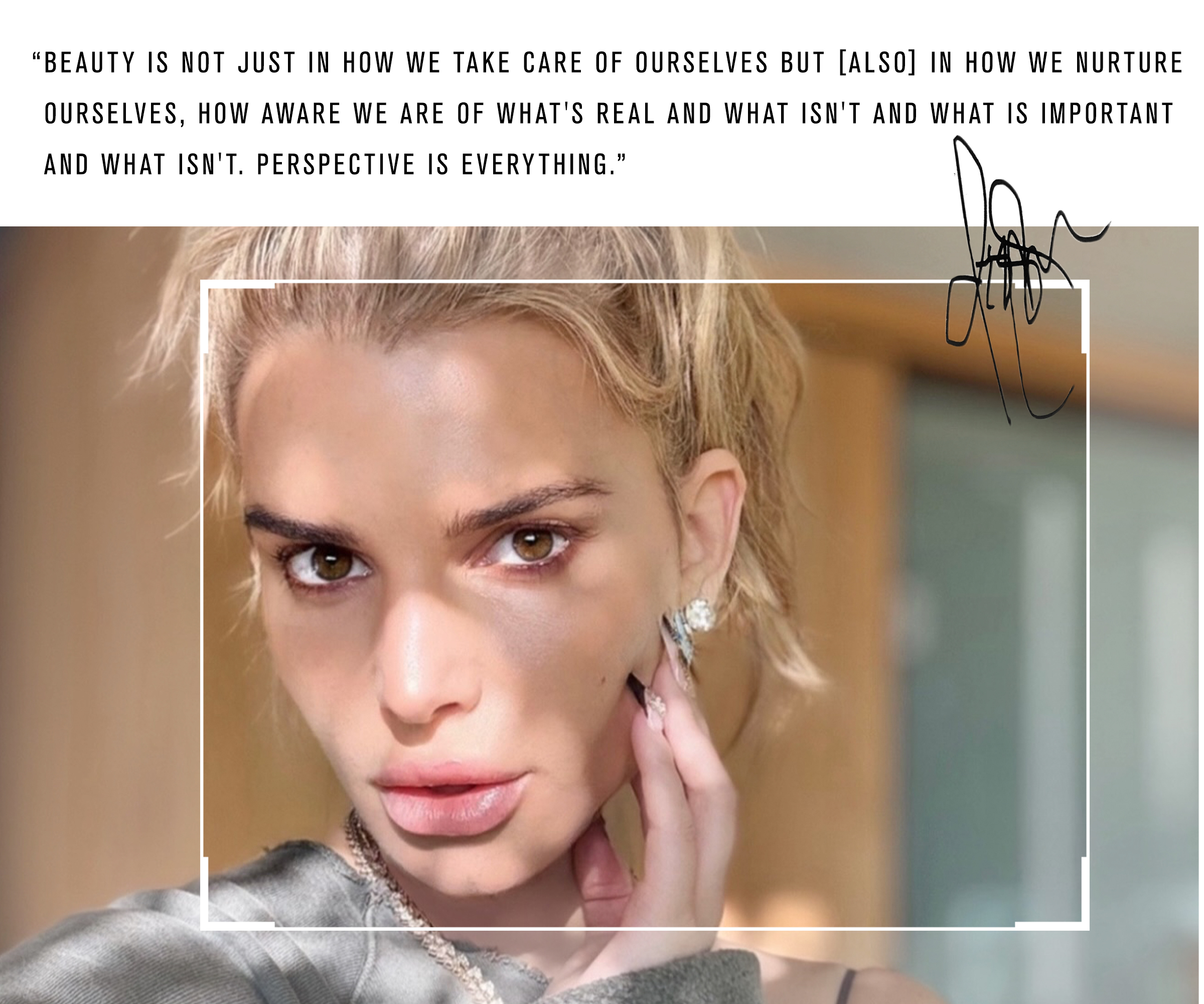 Jessica Simpson taking a selfie wearing a ponytail and gray sweatshirt.