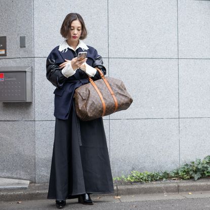 woman carrying a weekender bag
