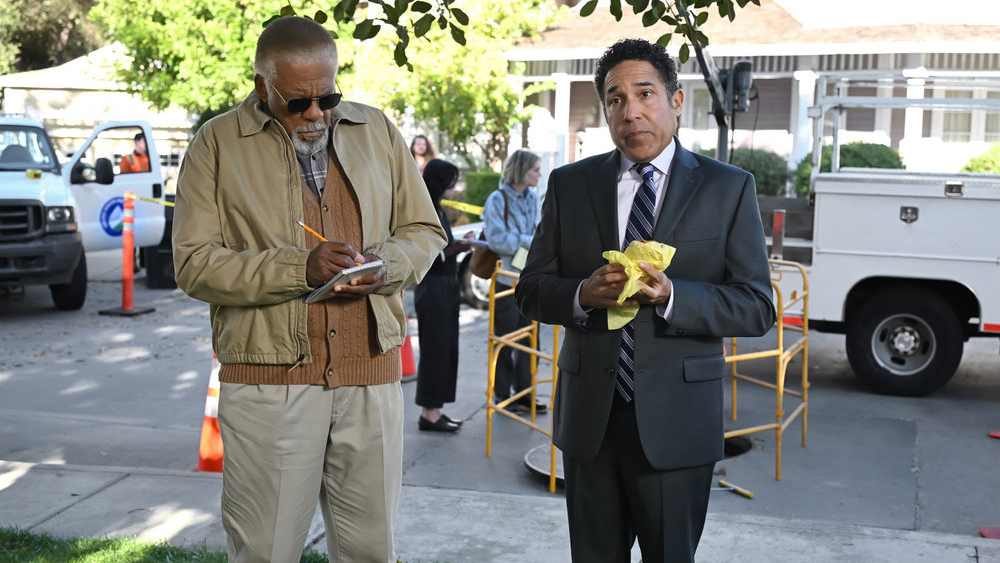 L-R: Barry (Duane Shepard Sr.) and Oscar (Oscar Nunez) standing on a street in a scene from Peacock's The Office" spinoff, "The Paper"