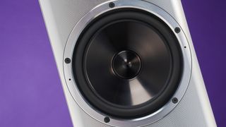 YG Acoustics Carmel 3 floorstanding speakers close up on mid/bass unit with purple backdrop