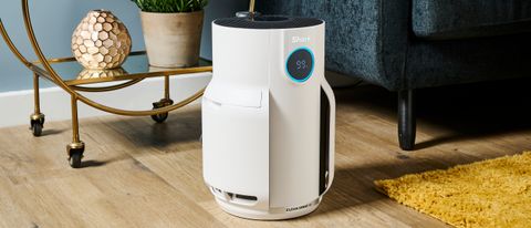 A white Shark NeverChange air purifier pictured in a living room environment.