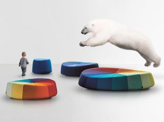 Polar bear jumping over a large colourful seating area