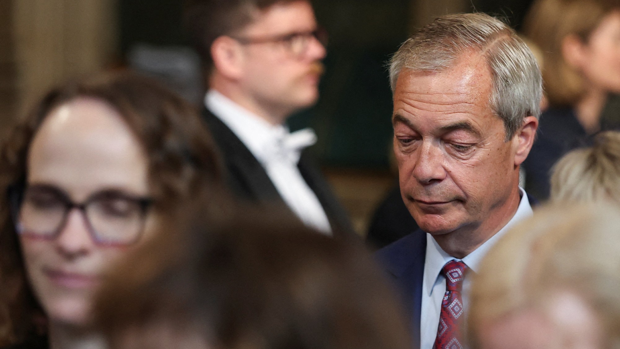 Nigel Farage with his eyes cast downwards during the State Opening of Parliament at the Palace of Westminster