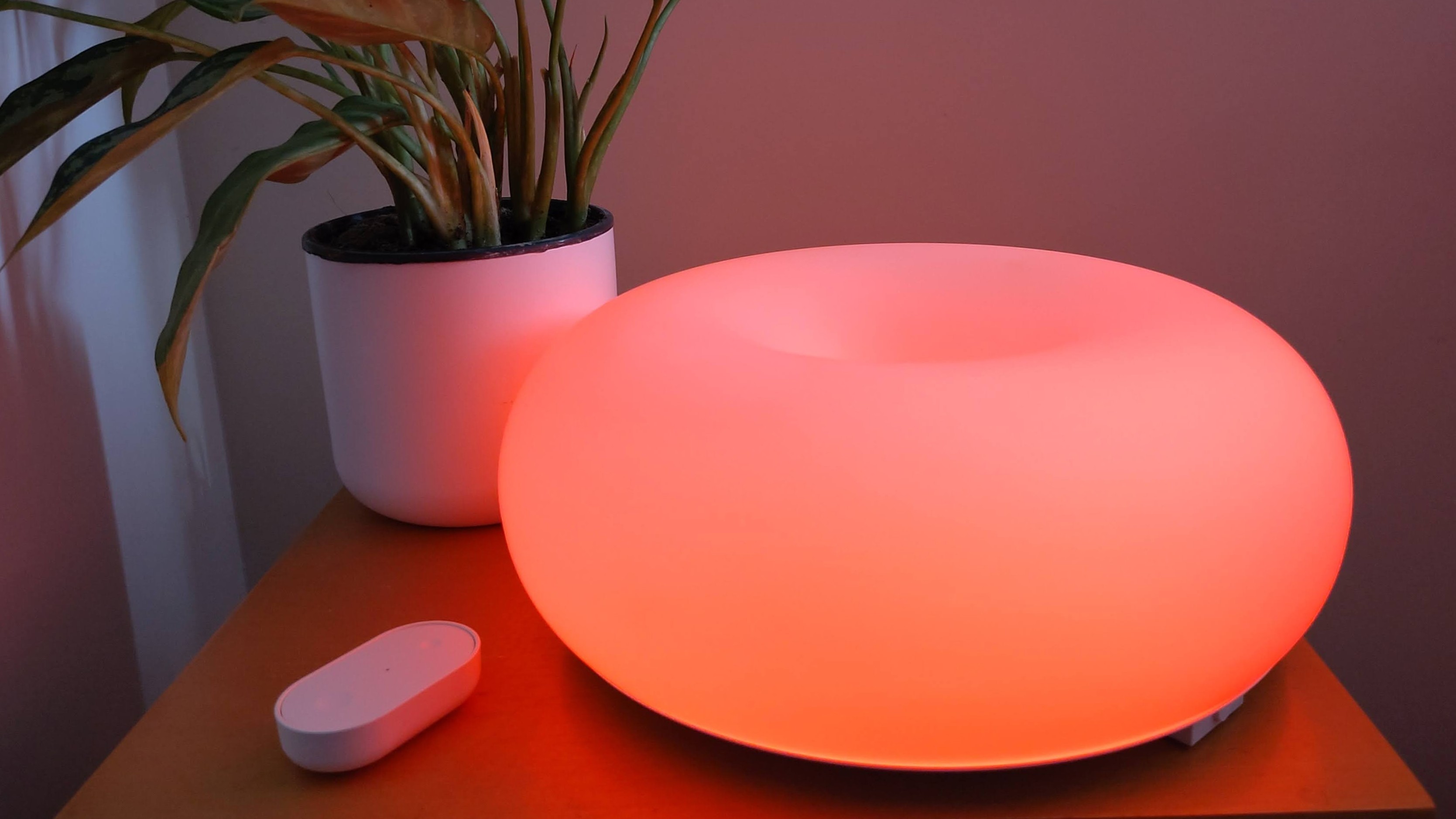 IKEA Varmblixt lamp illuminated red, on table, with remote control