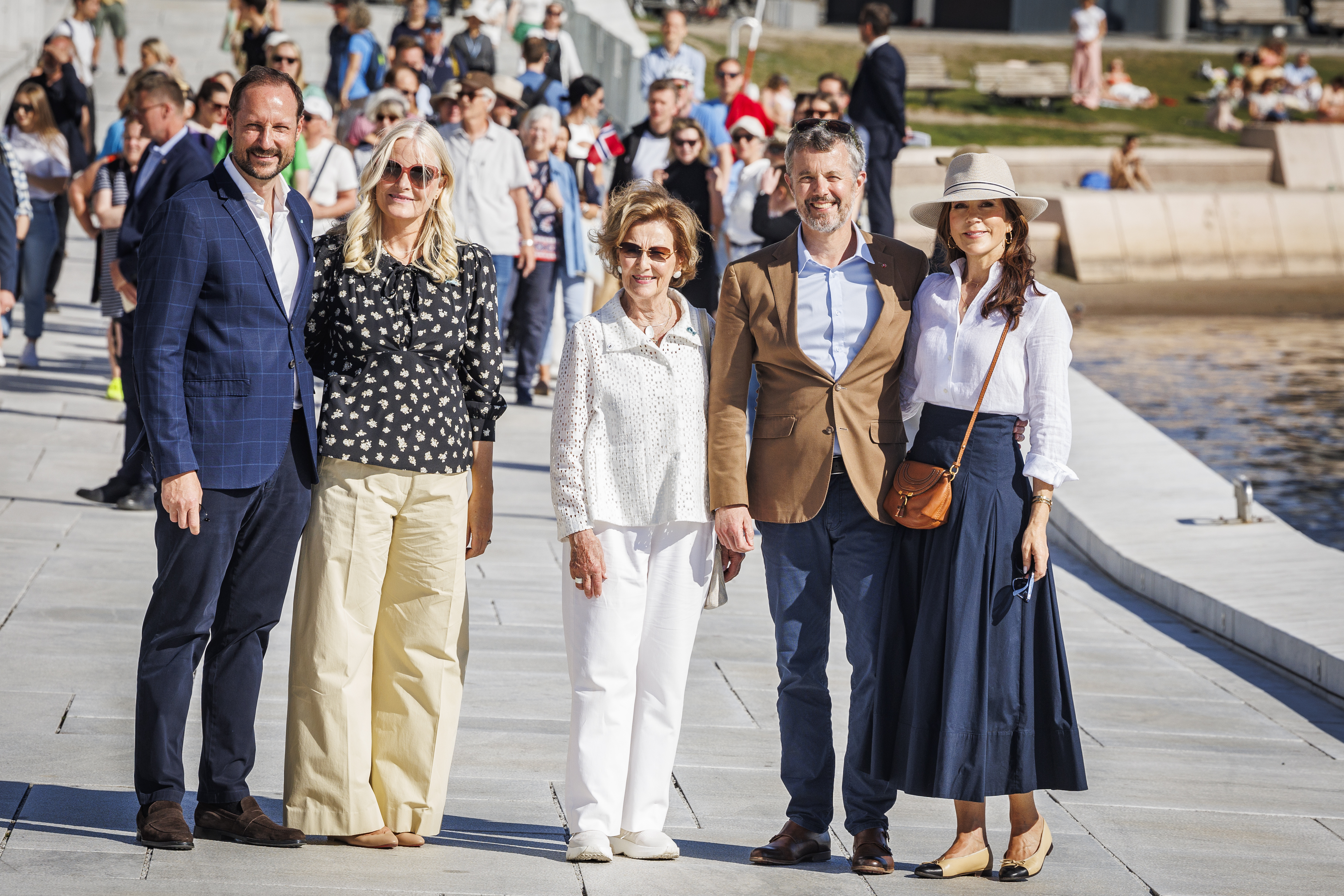 Crown Prince Haakon, Crown Princess Mette-Marit, Queen Sonia, King Frederik and Queen Mary posing by water in Norway wearing sunglasses