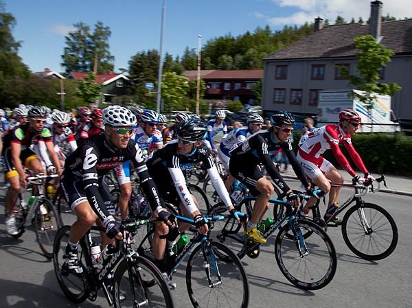 Hushovd and Arvesen chat after the start, as Boasson Hagen rides at the front.