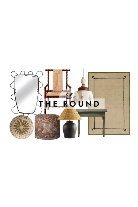 Spanish farmhouse decor, including a whimsical wrought iron wall mirror, ceramic plate, Turkish-print ottoman, woven shade table lamp, woven accent chair, green pedestal table, and Nate Berkus rug