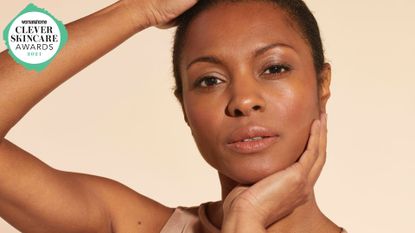 An image of a woman with her hands holding her face with the woman&home skincare awards logo