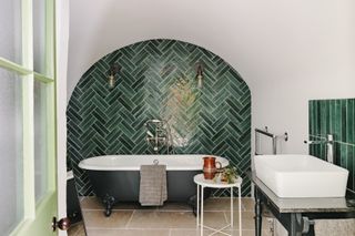 modern bathroom with green herringbone tiles