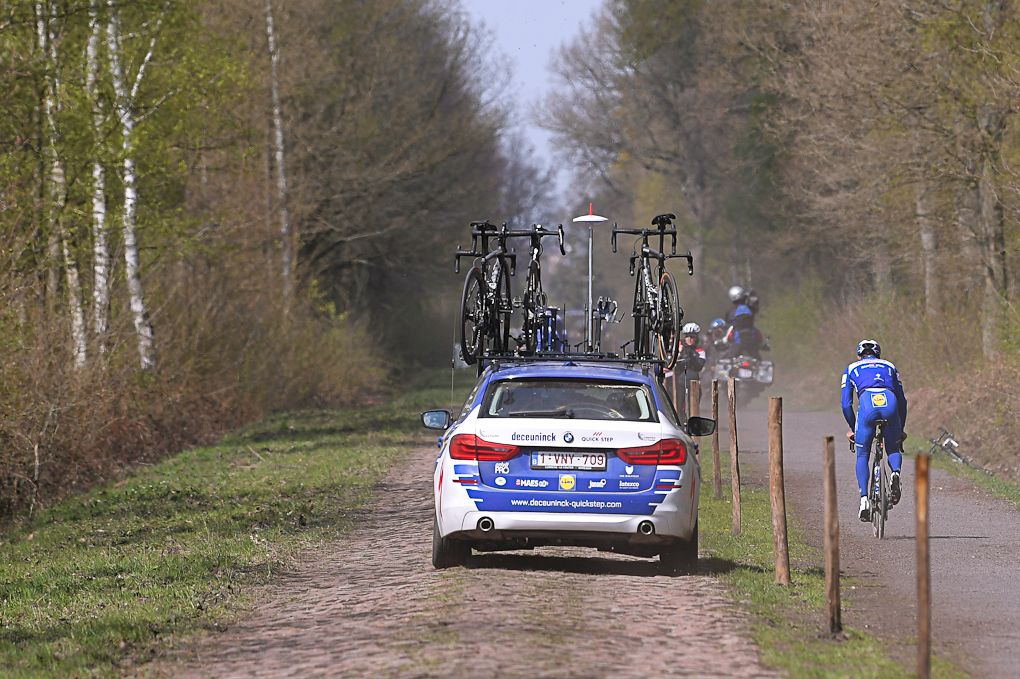 The Deceuninck-QuickStep car follows riders through the Arenberg,