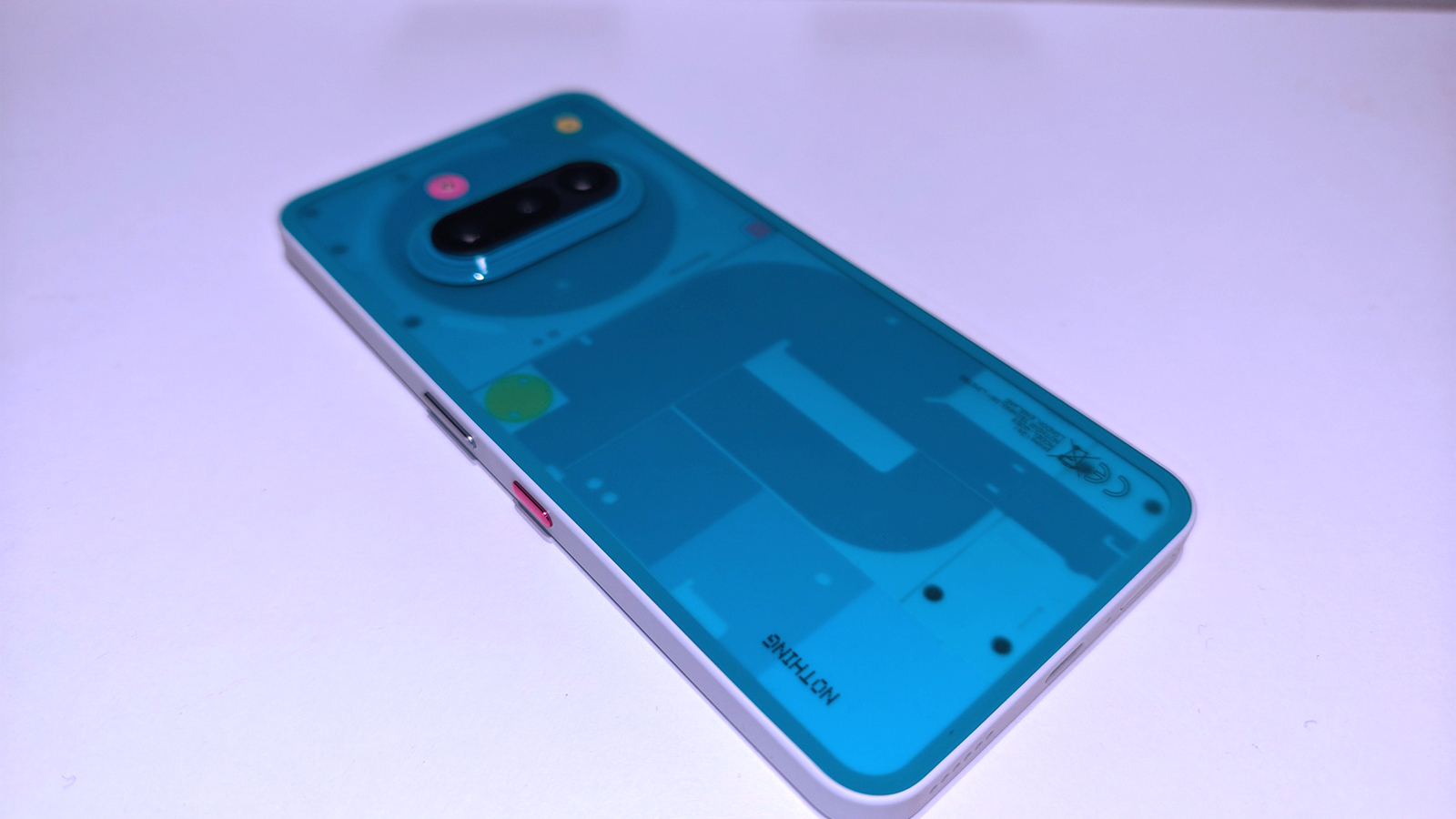 Nothing 3a Community Edition, a green phone on a white table