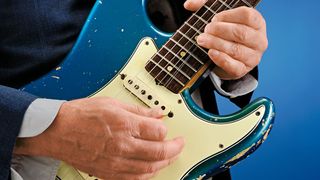Close-up of man bending string on an electric guitar