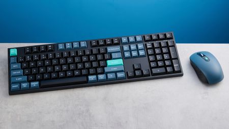 Keychron B36 keyboard and Keychron BM25 mouse photographed in front of a blue background. 
