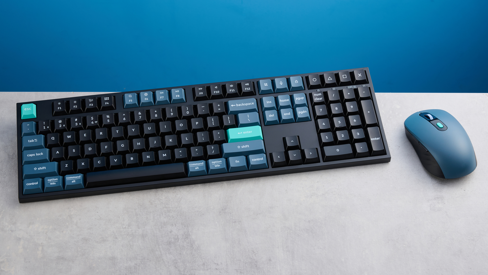 Keychron B36 keyboard and Keychron BM25 mouse photographed in front of a blue background.
