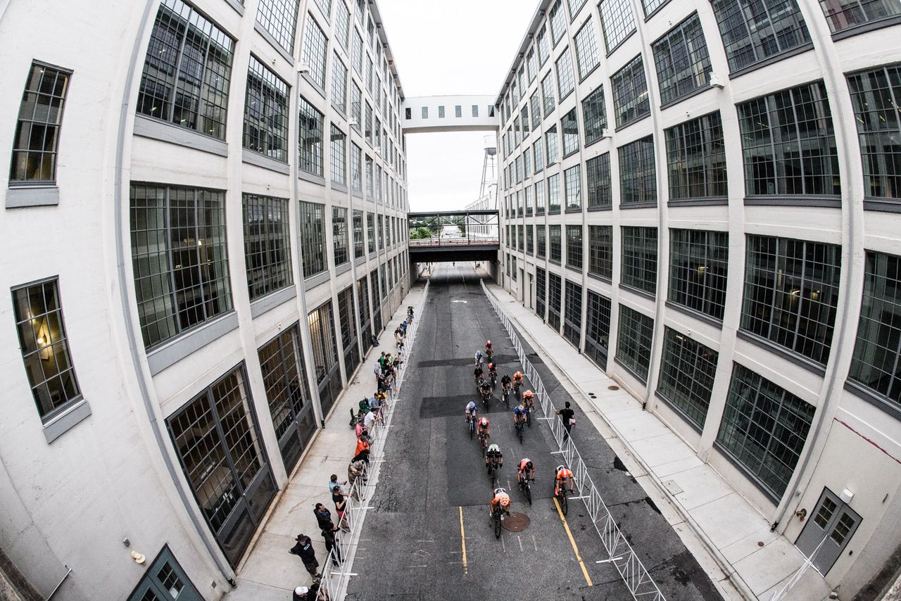 A break rides between old tobacco warehouses along the course.