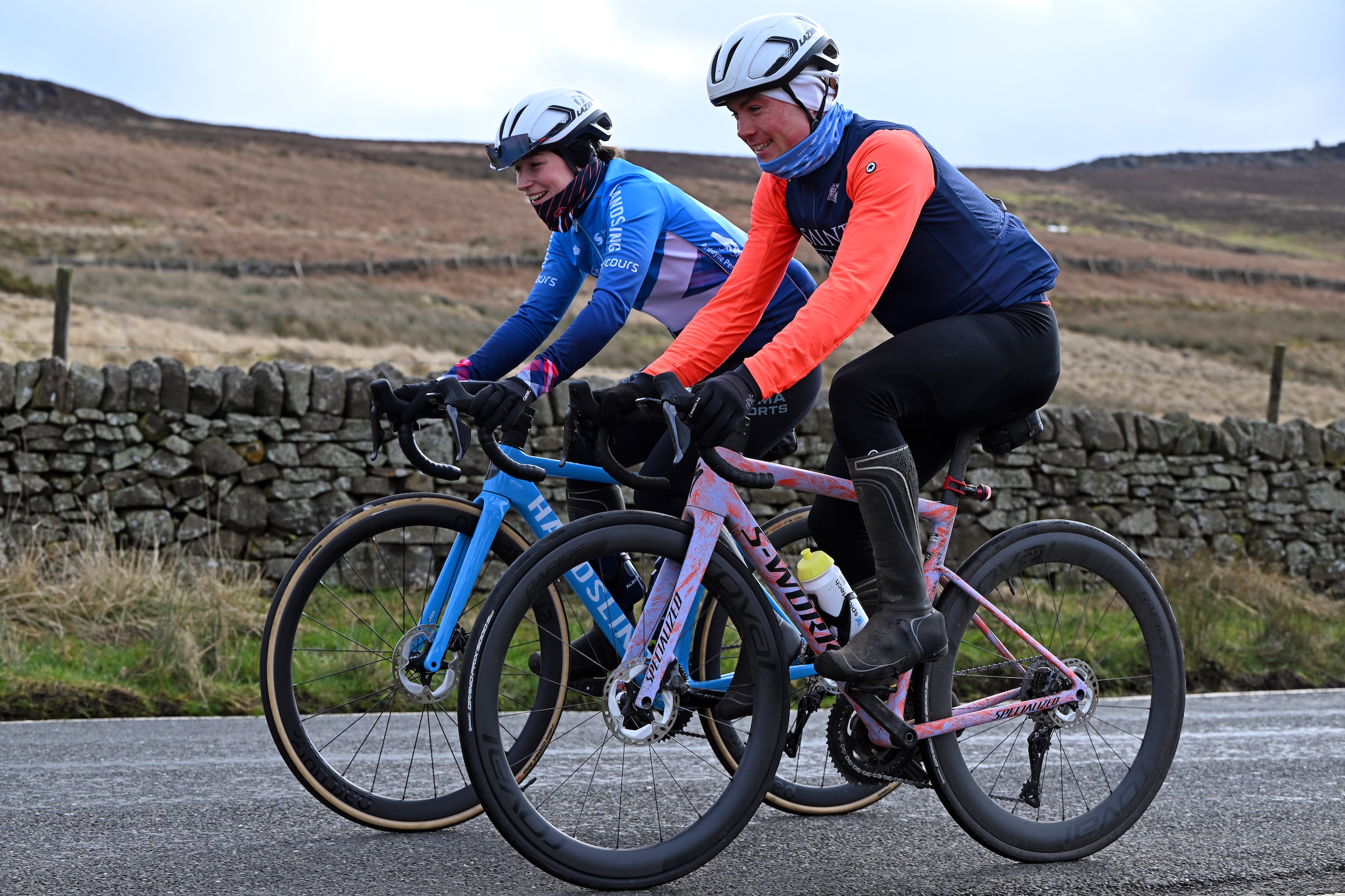 Two cyclists riding together in the winter wearing winter kit