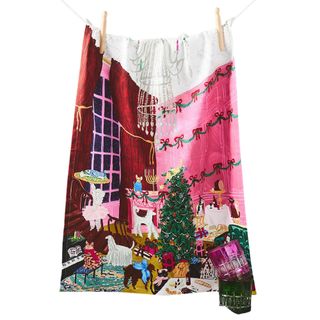 A pink festive tea towel decorated with dogs and cats