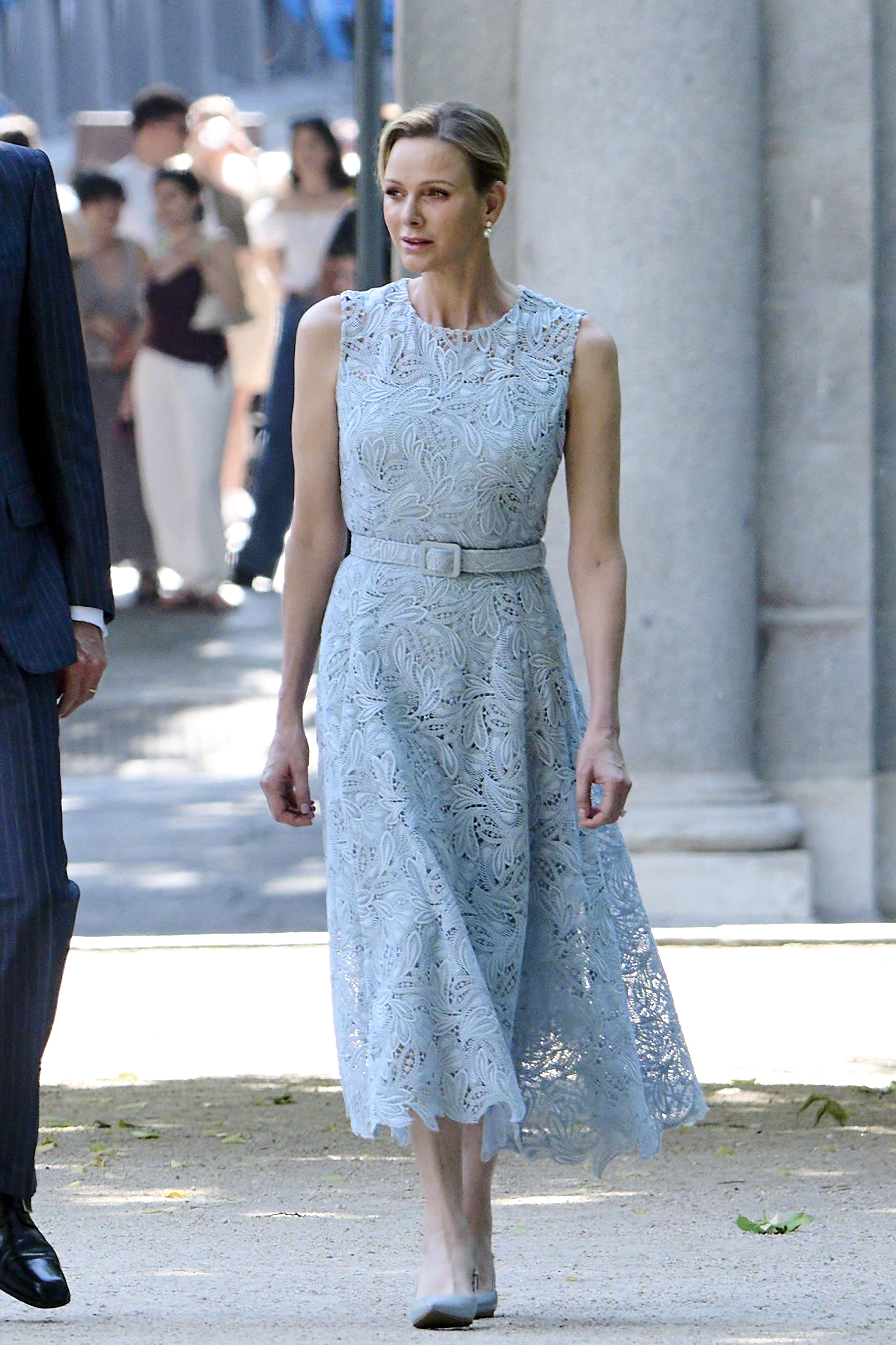 Princess Charlene walking in a blue dress